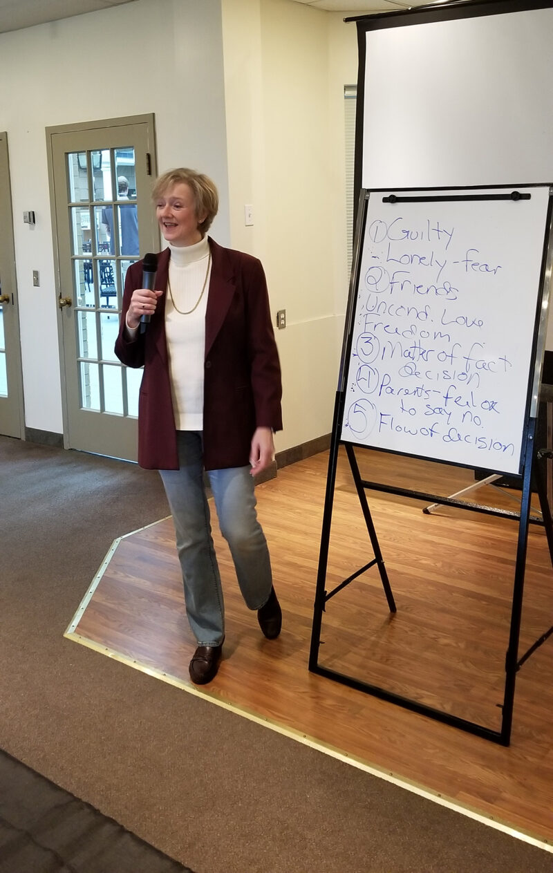Angela Nyhuis, founder and master trainer, speaking at a live hypnosis and NLP training session